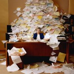 Office Worker with Mountain of Paperwork Office Worker with Mountain of Paperwork