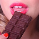 woman eating chocolate woman eating chocolate